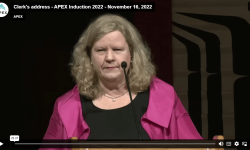 Picture of Clerk (Janice Charette) speaking on stage at event