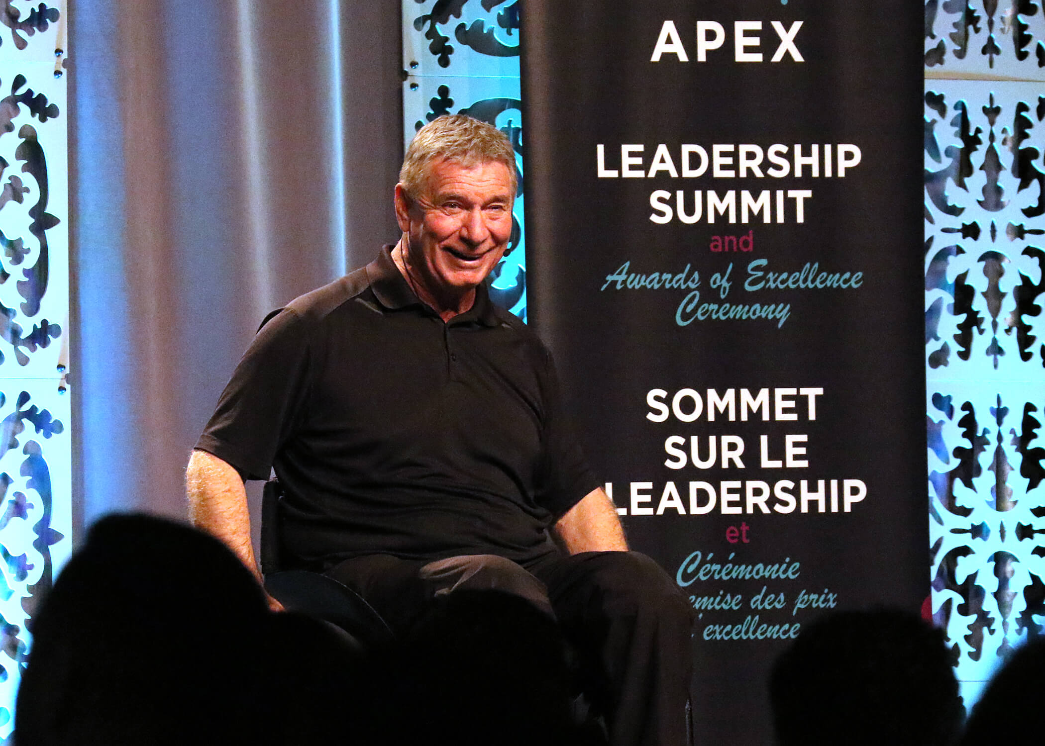 Photo of Rick Hansen on stage at Summit